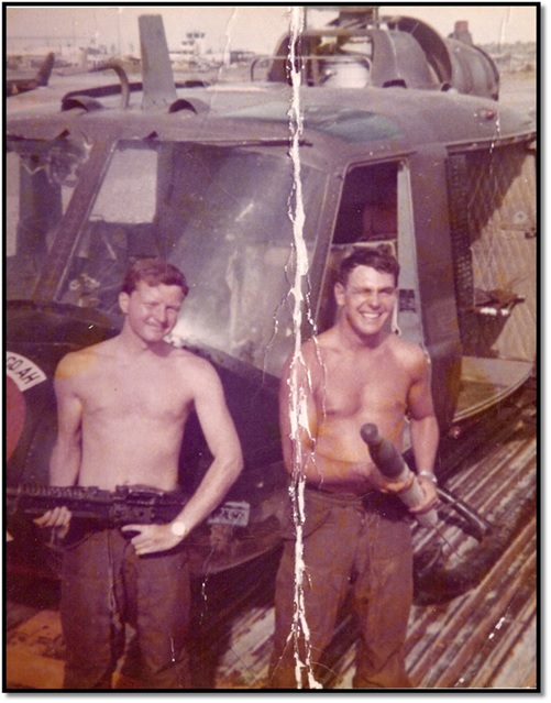 A 21-year-old McManus, left, is pictured in front of a UH-1 Iroquois “Huey” helicopter that he flew as a warrant officer during the Vietnam War. Courtesy of Greg McManus