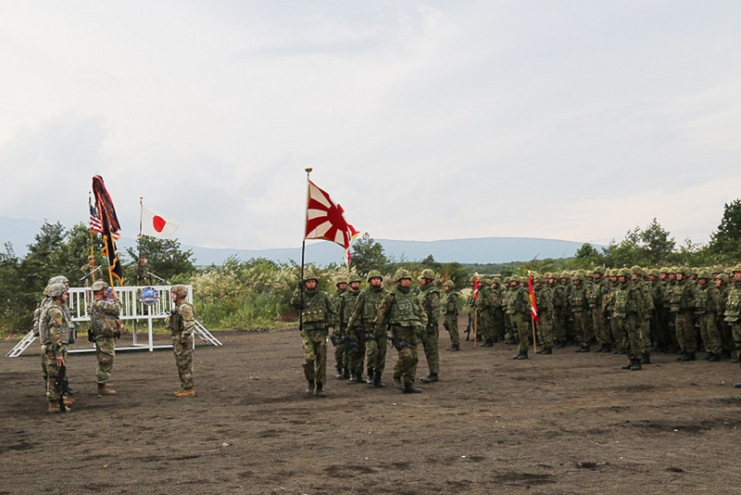 JGSDF soldiers and U.S. soldiers participate in the Orient Shield 2017 opening ceremony at Camp Shin Yokotsuka, Sept. 11, 2017.
