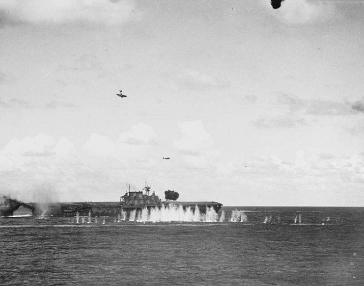 A Japanese Type 99 Aichi D3A1 dive bomber (Allied codename “Val”) trails smoke as it dives toward the U.S. Navy aircraft carrier USS Hornet (CV-8), during the morning of 26 October 1942. This plane struck the ship’s stack and then her flight deck.