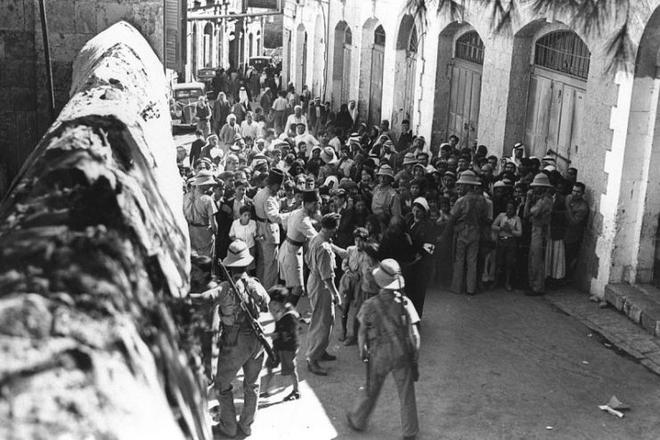 Arab masses await bread distribution during a break in the Curfew imposed due to violent Arab riots against Jews in Jerusalem during the British mandate.