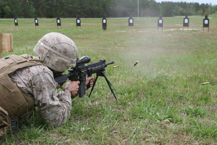 A U.S. Marine practices firing an M27 IAR on fully automatic fire