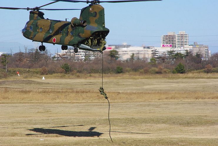 1st Airborne Brigade paratroopers fast rope from a Kawasaki CH-47 chopper during a public exhibition at Camp Narashino.