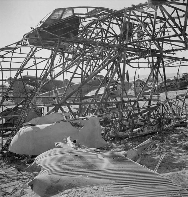 Wrecked German planes at El Aouiana airport, Tunis, Tunisia, in May 1943. In front lies the wing of a Junkers Ju 52/3m transport, one which is also visible in the background. The prominent structure are the remains of a Messerschmitt Me 323D Gigant transport.