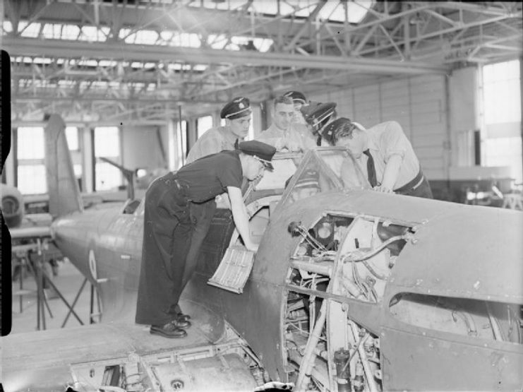 A class of Czech airmen receiving a practical lecture on the engine controls of a Battle