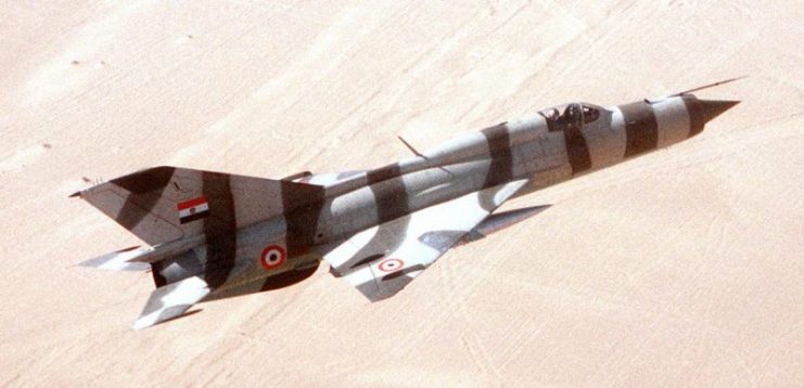 A right side view of aircraft in flight over the desert during exercise Bright Star ’82. The aircraft is Egyptian MiG-21PFM.