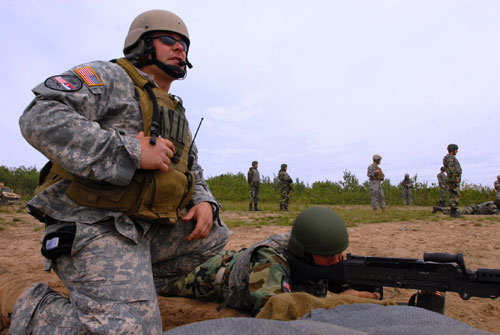 A soldier of from Company B, 2nd Battalion, 19th Special Forces Group instructs a Serbian soldier on the M240B
