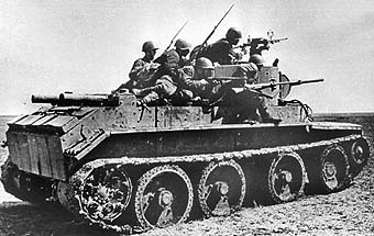 A Soviet BT-7 light tank carrying men forward