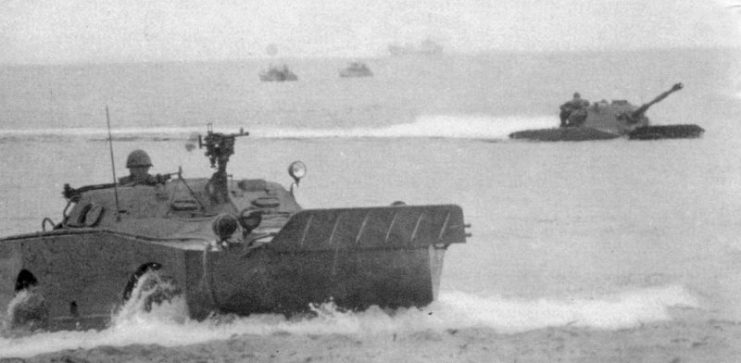 A swimming Polish BRDM-1 and PT-76 light tank during an amphibious exercise. Notice the raised trim board in the front of the vehicle.