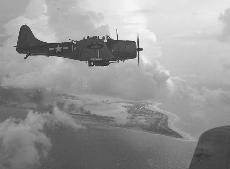 A U.S. Navy Douglas SBD-5 Dauntless dive bomber of Bombing Squadron 5 (VB-5) from the aircraft carrier USS Yorktown (CV-10) over Wake Island, 5 or 6 October 1943.