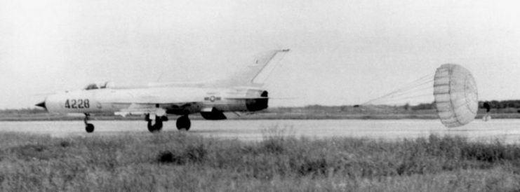 A Vietnamese People’s Air Force Mikoyan Gurevich MiG-21PF deploying its braking chute while landing after a mission. The aircraft is armed with AA-2 Atoll air-to-air missiles.