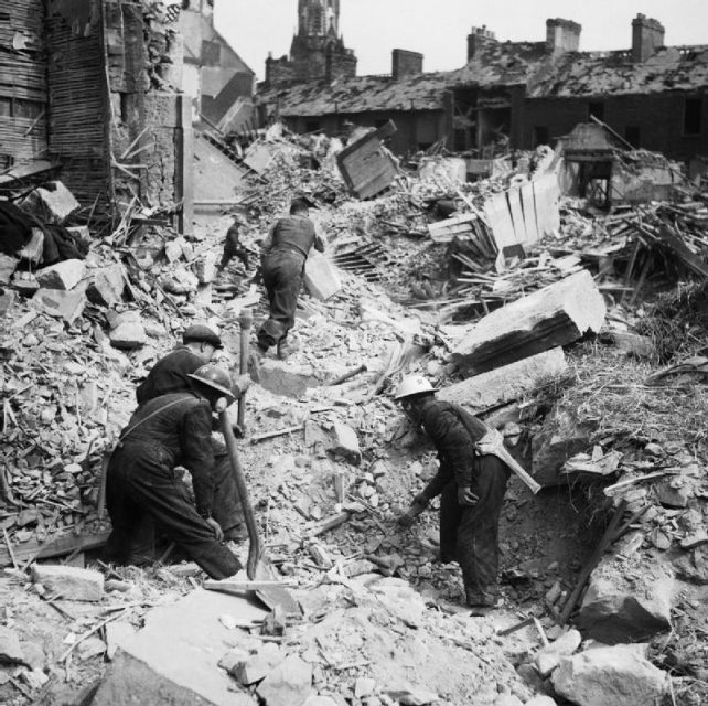 Rescue workers search through the rubble of Eglington Street in Belfast, Northern Ireland after a German Luftwaffe air raid.
