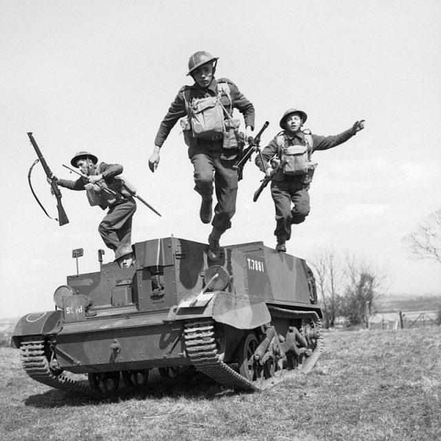 British troops leap from their Universal Carrier during an exercise