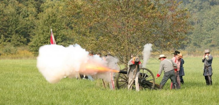 Confederate artillery reenactors fire on Union troops during a Battle of Chickamauga reenactment in Danville, Illinois. By Daniel Owens CC BY-SA 4.0