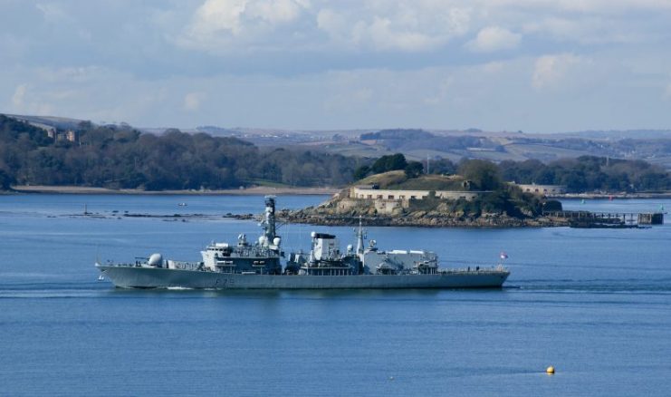 HMS Portland (Type 23 frigate F79) passing Drake’s Island in Plymouth Sound, Devon,  heading out into the English Channel. By Herbythyme – CC BY-SA 4.0