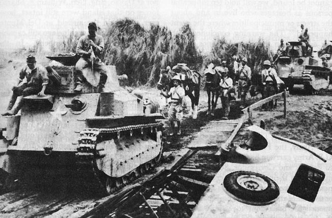 Japanese light tanks moving toward Manila on the day the city was entered.