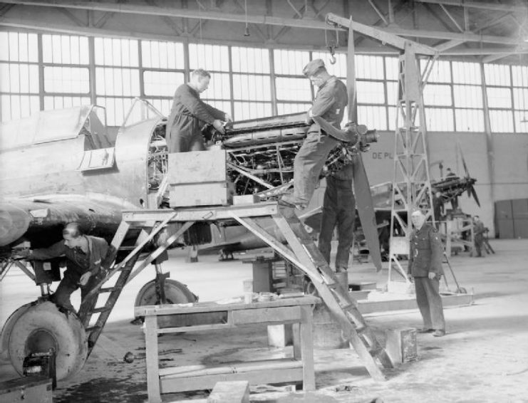 Mechanics of No. 226 Squadron RAF overhaul the engines of their Battles in a hangar at Reims, France