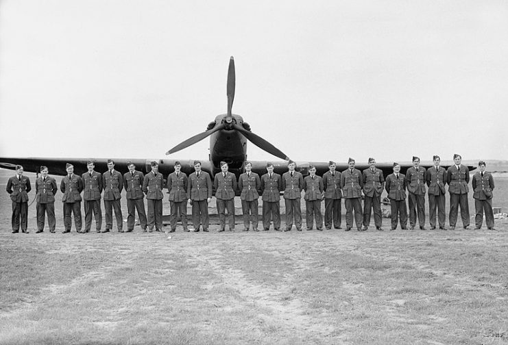 Officers of No. 103 Squadron lined up in front of a Battle at Betheniville, France