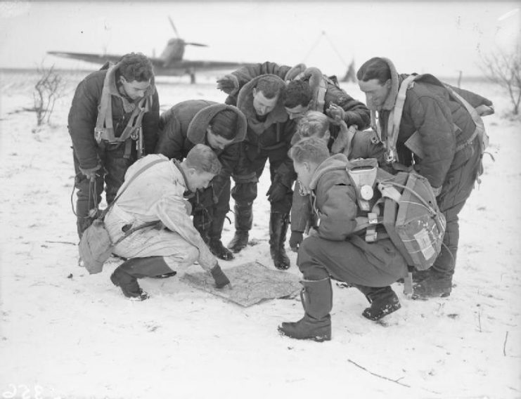 Royal Air Force- France, 1939-1940 Fairey Battle crews of No. 12 Squadron RAF check their maps on the snow-covered airfield at Amifontaine.
