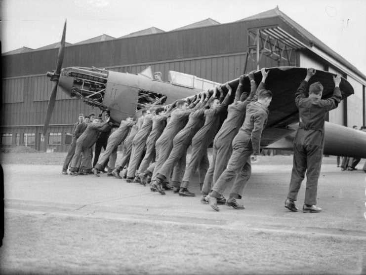 Royal Air Force Training Command, 1939-1940. Trainees manhandling a Fairey Battle to the hangar at No. 2 School of Technical Training, Cosford, Shropshire.