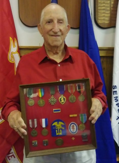 Jack Sandwith is pictured with the shadowbox containing the medals he earned for his service in World War II. The U.S. Army veteran was part of the first wave of landings on Omaha Beach during D-Day on June 6, 1944. Courtesy of Jeremy P. Amick