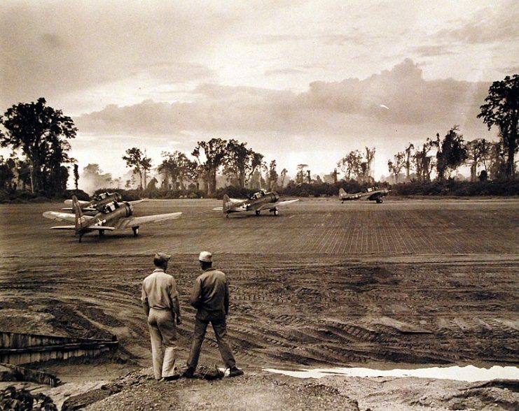 SBD’s of Marine Scout Bombing Squadron 236 (VMSB-236) line up for early morning take-off from Bougainville Island air strips.