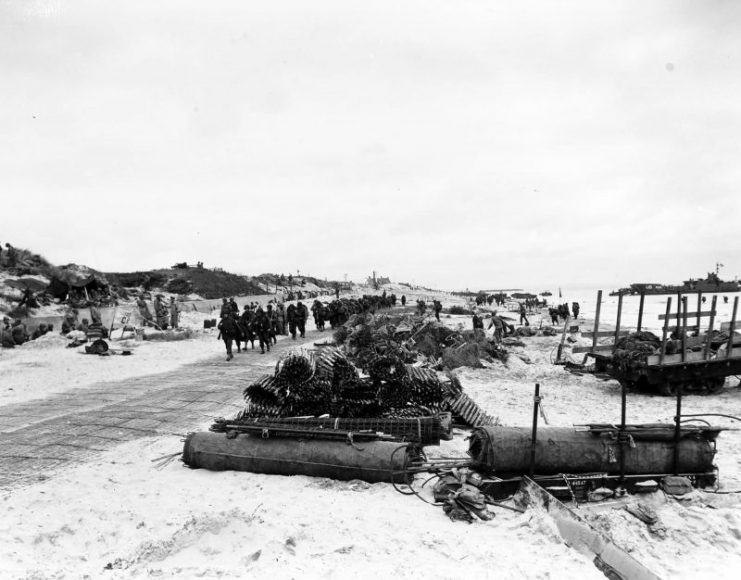 Scene on Utah Beach with troops marching up the road 9 June 1944