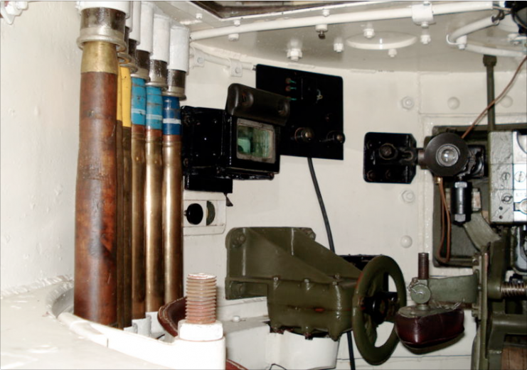 Interior of T-26 mod. 1933 turret. Ammunition stowage is on the left side. The side observation device is visible, as is the revolver porthole, which is closed with a plug. Parola Tank Museum in Finland.Photo Balcer CC BY 2.5