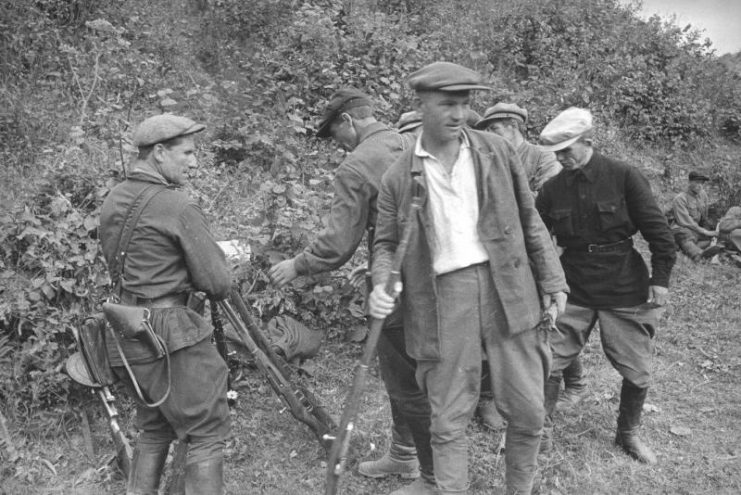 Soviet Partisans being armed.
