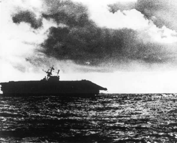 The U.S. Navy aircraft carrier USS Hornet (CV-8), severely listing, is abandoned by her crew at about 17-00 hrs during the Battle of the Santa Cruz Islands on 26 October 1942.