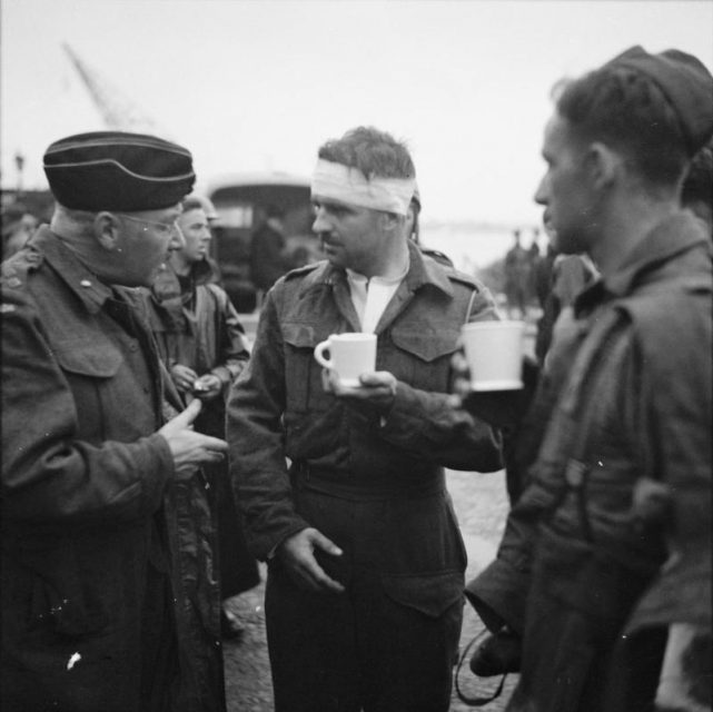 The Dieppe Raid, 19 Aug 1942.Captain Jock Anderson of the Royal Regiment of Canada, cup of tea in hand, recounts his experiences to Brigadier Tees after disembarking at Portsmouth.