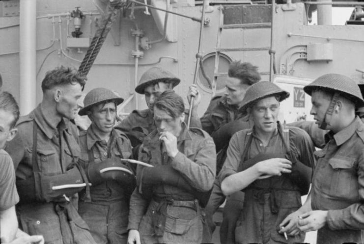 Some of the Canadian troops resting on board a destroyer after the Combined Operations daylight raid on Dieppe. The strain of the operation can be seen on their faces.