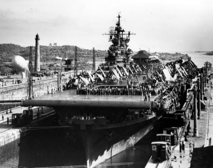 USS Bunker Hill (CV-17) with crew members lining the flight deck passes through the Panama Canal en route to the PTO – 17 September 1943