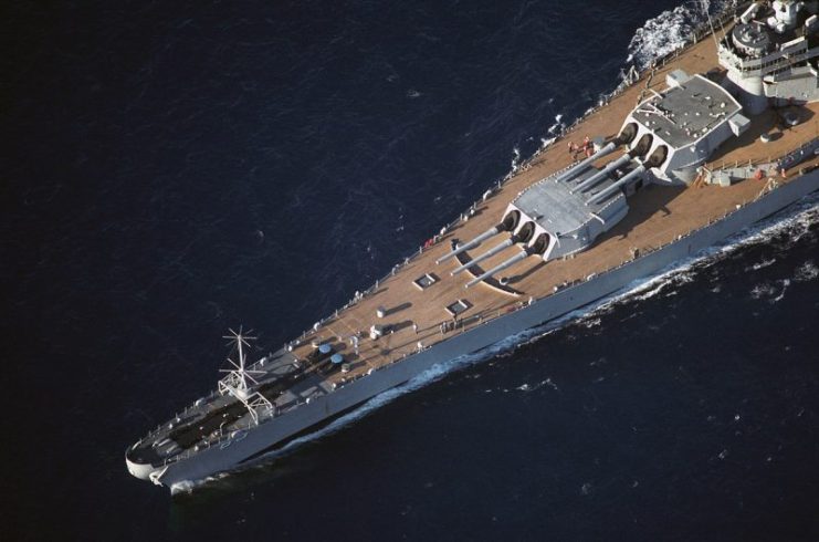 An aerial port view of the forward half of the battleship USS Missouri (BB-63) while the ship is underway.