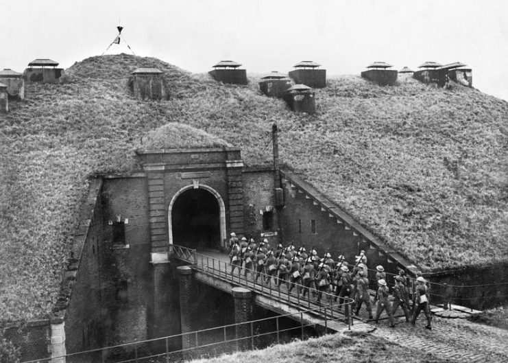 Troops of 51st Highland Division march over a drawbridge into Fort de Sainghain on the Maginot Line, 3 November 1939