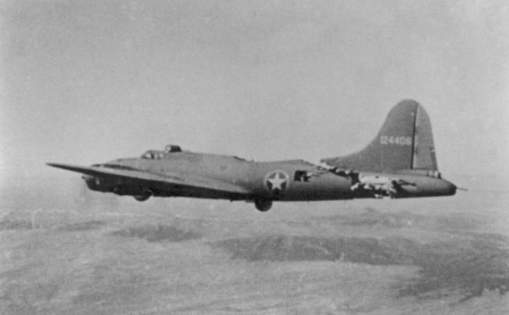 The severely damaged B-17 continues to fly after a collision with an attacking Bf 109 fighter, eventually landing without injury to the crew.