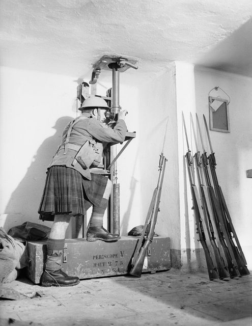 A soldier from the Cameron Highlanders looks through a periscope in the Fort de Sainghain on the Maginot Line, 3 November 1939.