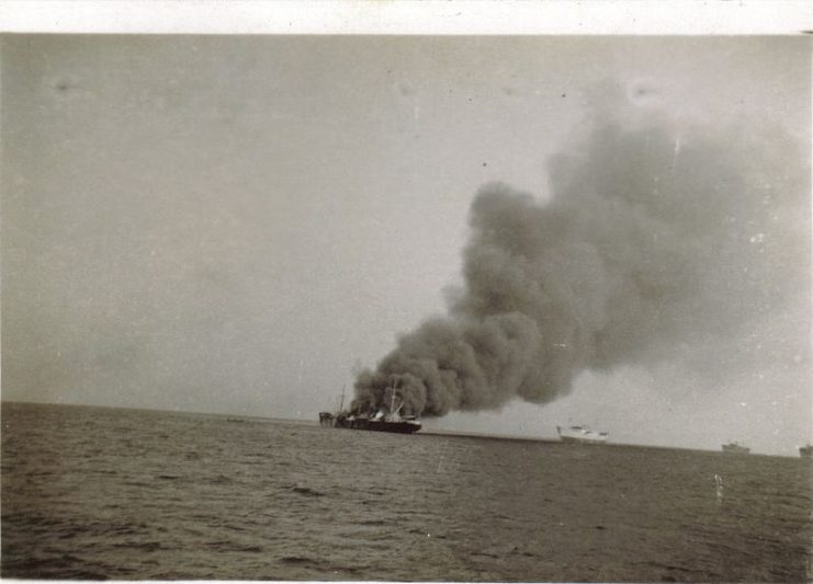 SS Tacoma burning after being hit by British naval shellfire. 6 Danish seamen killed. By Frederick Milthorp CC BY-SA 3.0