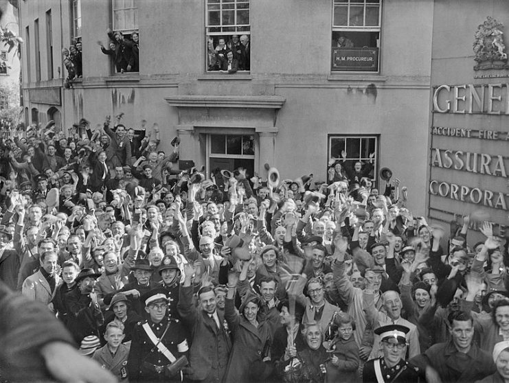 Crowds of people gathered outside the General Assurance Corporation building in St Peter Port, Guernsey to welcome the British Task Force sent to liberate the island from German occupation, 10 May 1945.