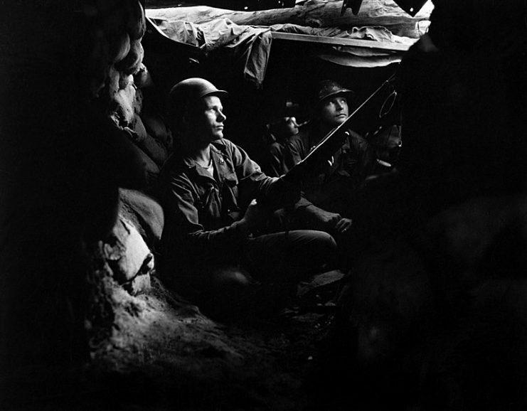 U.S. Army infantrymen of the 27th Infantry Regiment, near Heartbreak Ridge, take advantage of cover and concealment in tunnel positions, 40 yards from the Communists on August 10, 1952.