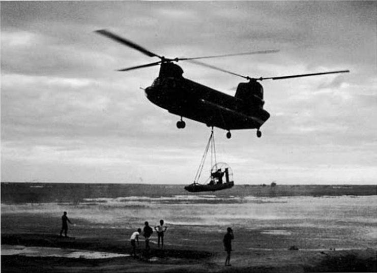 A CH-47 Chinook airlifts a MIKE Force Hurricane Aircat airboat from Don Phuc to the Seven Mountains in Vietnam.