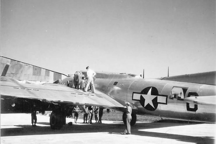 B-17 Flying Fortress Being Serviced by Ground Crew on Field