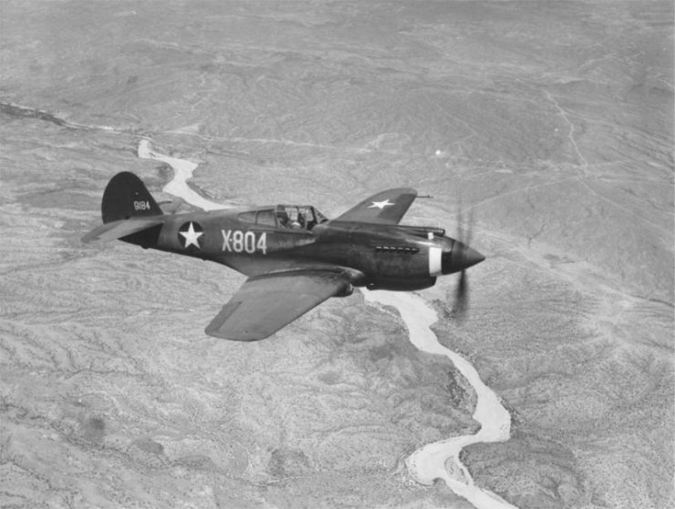 A three-quarter view of a P-40B, X-804 (s/n 39-184) in flight.