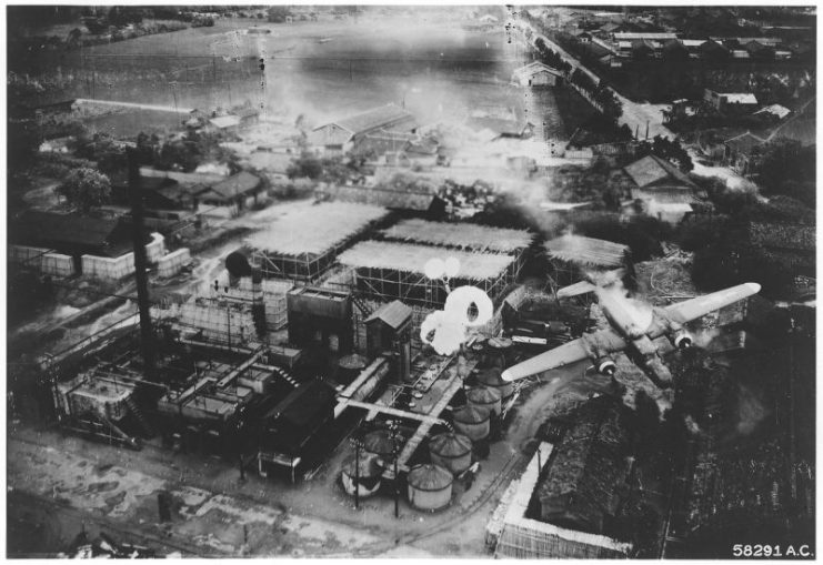 Spectacular crash at Byoritsu oil refinery, Formosa, was photographed by a B-25 of the 5th Air Force’s 345th Bomb Group on 26 May 1945. Just as it released its string of parafrags B-25 NO. 192 was hit by flak from a camouflaged battery and trails smoke. A gaping hole is visible on the piolot’s side.