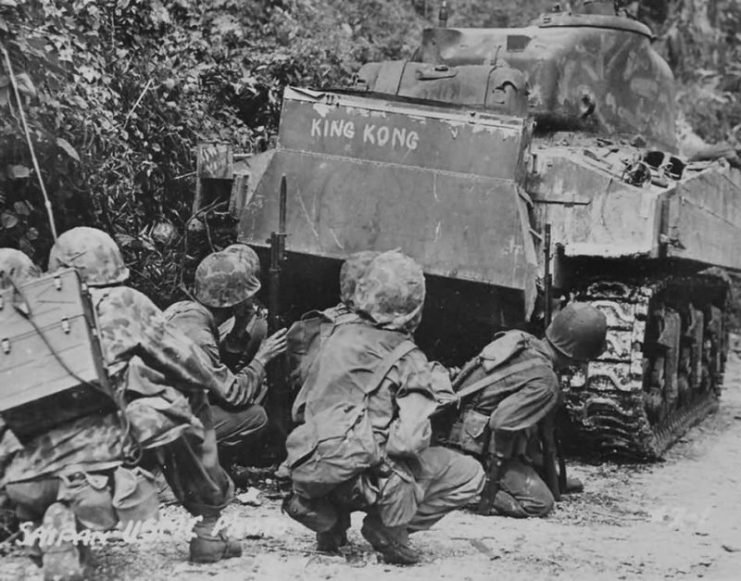 Marines take cover behind a M4A2 Sherman named King Kong – Saipan July 8, 1944. Tank of the Company C, 4th Tank Battalion.