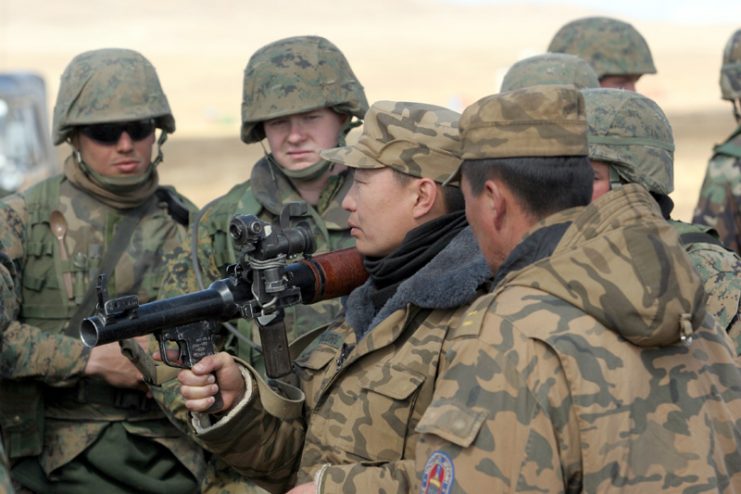 A Mongolian soldier with an RPG launcher. Note that it is not loaded with a rocket/warhead.