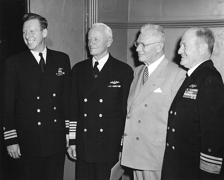 Vice Admiral William L. Calhoun, USN (Retired), (at right) With (from left to right center) Commander Eugene B. Fluckey, Fleet Admiral Chester W. Nimitz, and an unidentified civilian, on his receiving the rank of full Admiral.Coronado, California, 21 January 1953.