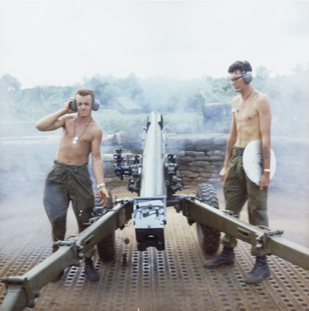 Nui Dat, South Vietnam. 1966. Two members of 103 Field Battery, Royal Australian Artillery, firing a 105mm L5 pack Howitzer from a gun pit at 1st Australian Task Force (1ATF).