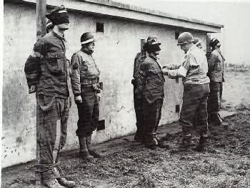Pernass, Billing, and Schmidt were lined and tied up for execution by firing squad after a U.S. military court found them guilty of espionage. They were captured behind U.S. lines in U.S. uniforms during the Battle of the Bulge. By Monkey republic CC BY 3.0