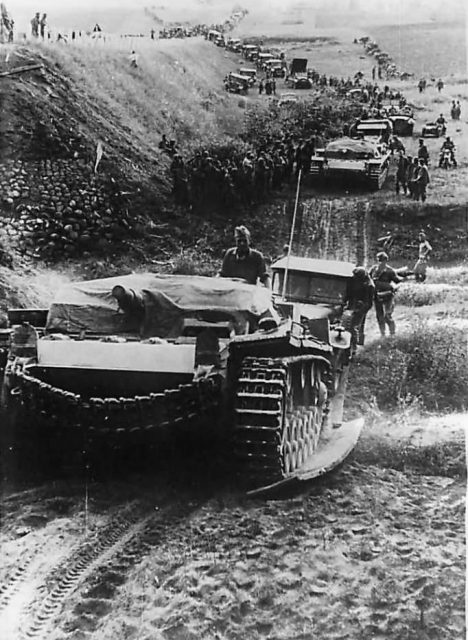 StuG leading a long column of troops and vehicles somewhere on the Eastern Front