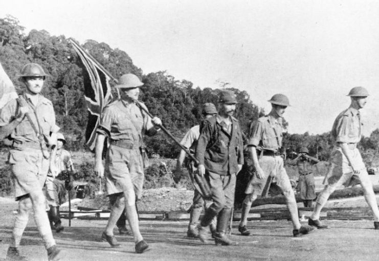 Lieutenant-General Arthur Ernest Percival, (right), led by a Japanese officer, walks under a flag of truce to negotiate the capitulation of Allied forces in Singapore, on February 15, 1942. It was the largest surrender of British-led forces in history.